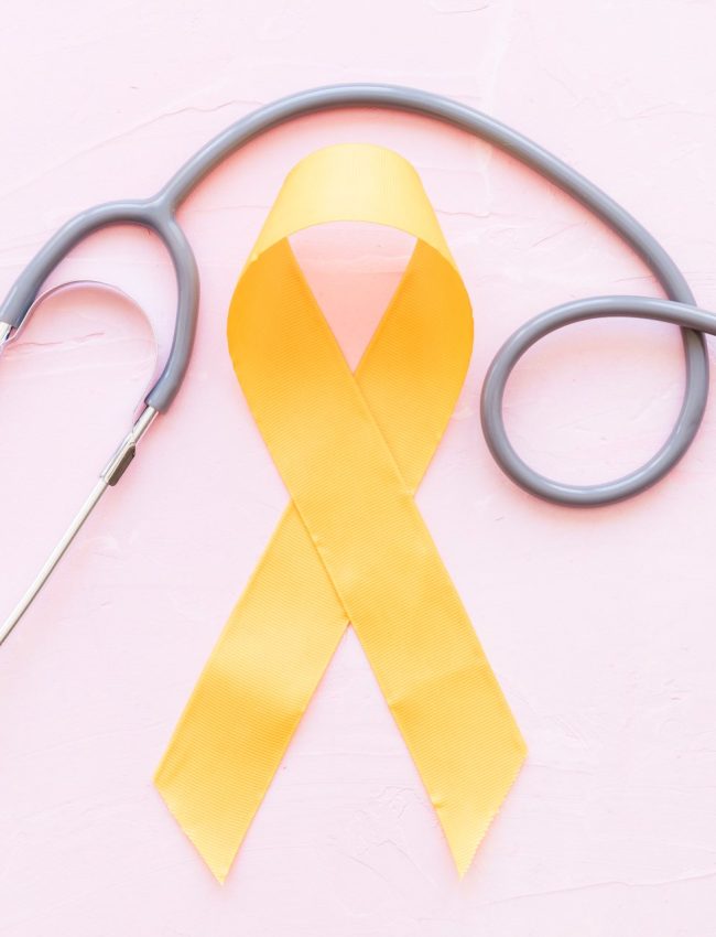 sarcoma-bone-cancer-yellow-ribbon-with-stethoscope-pink-background (1)